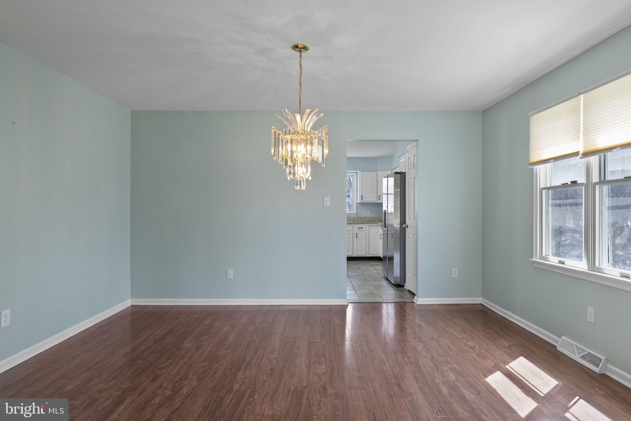 218 Crestview Avenue Absecon, NJ 08205 - Photo 14 of 67 a view of a room with wooden floor chandelier and windows