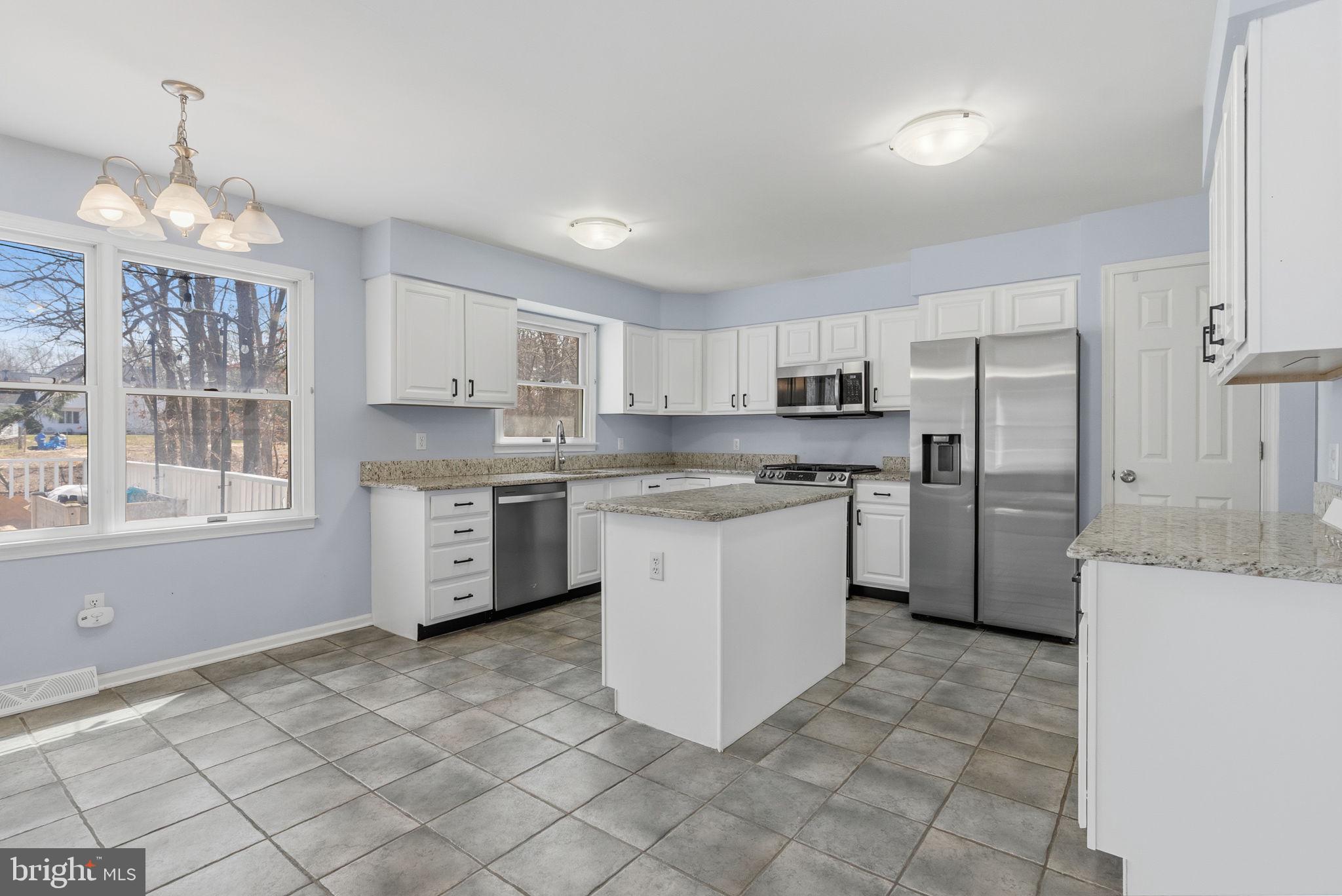 218 Crestview Avenue Absecon, NJ 08205 - Photo 18 of 67 a kitchen with granite countertop a refrigerator sink stove and cabinets