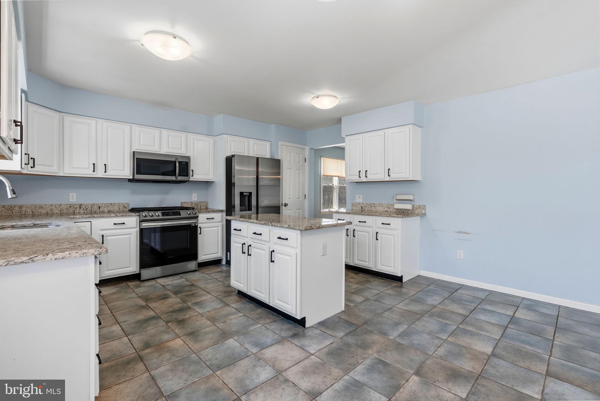 218 Crestview Avenue Absecon, NJ 08205 - Photo 19 of 67 a kitchen with granite countertop white cabinets and stainless steel appliances