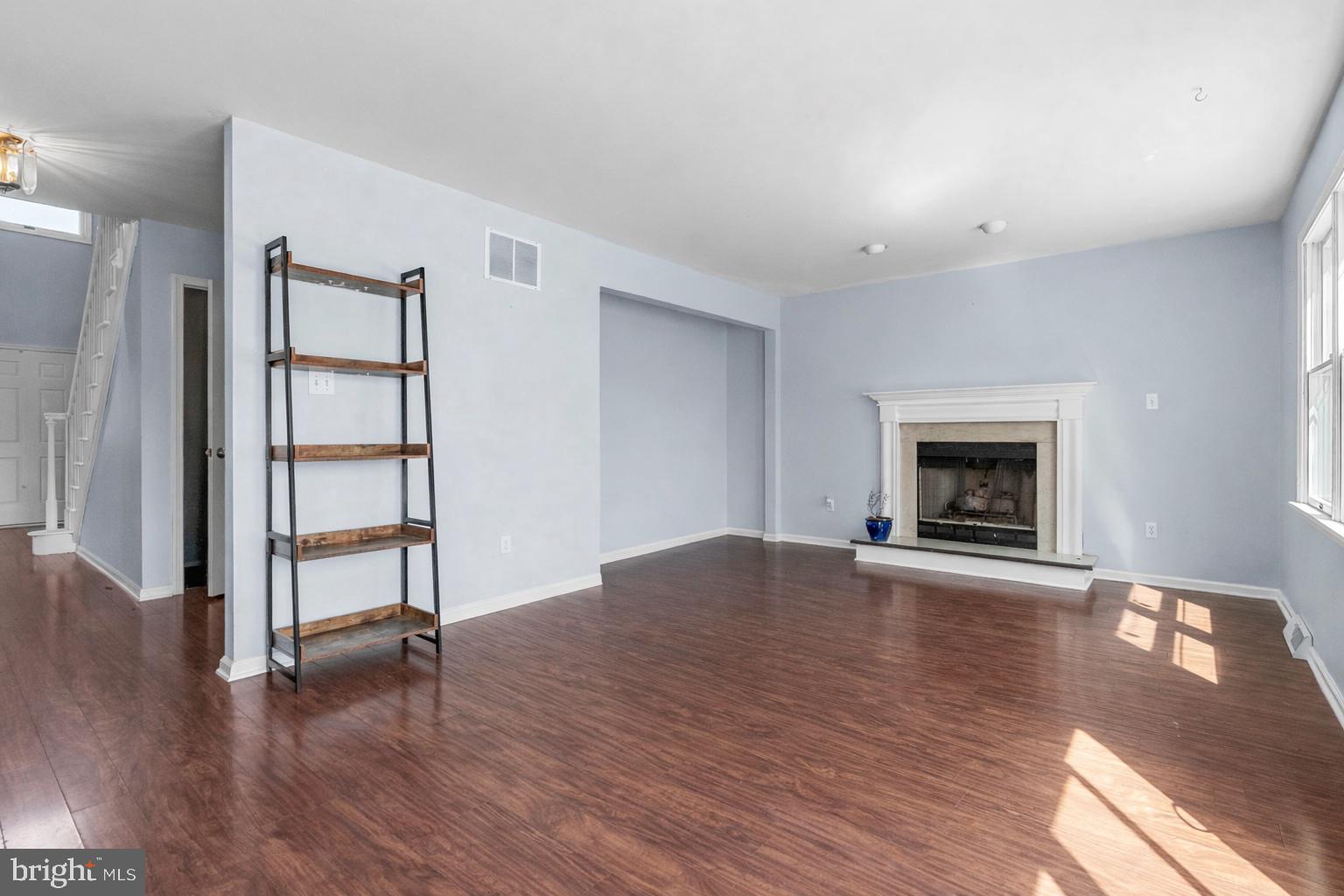 218 Crestview Avenue Absecon, NJ 08205 - Photo 22 of 67 an empty room with wooden floor a fireplace and a window