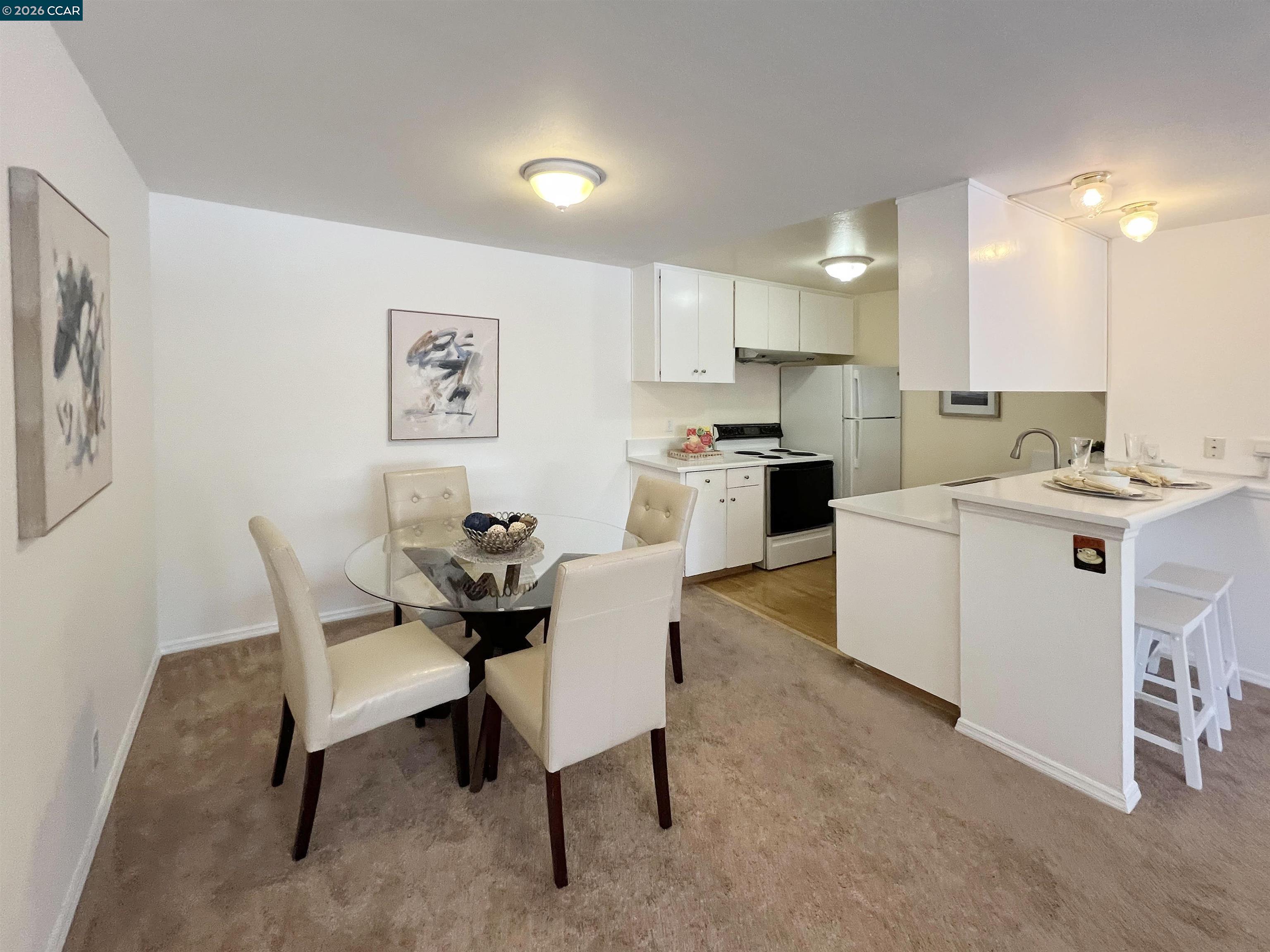 9085 Alcosta Boulevard, Unit 424 San Ramon, CA 94583 - Photo 10 of 21 a view of kitchen with cabinets table and chairs
