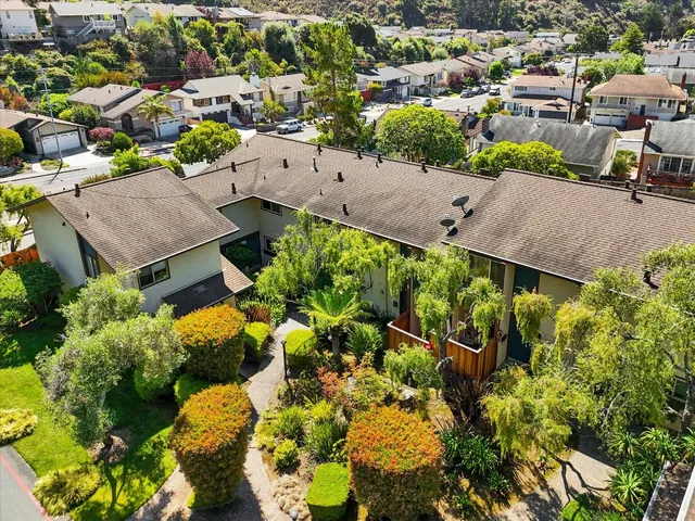 an aerial view of a houses with a yard