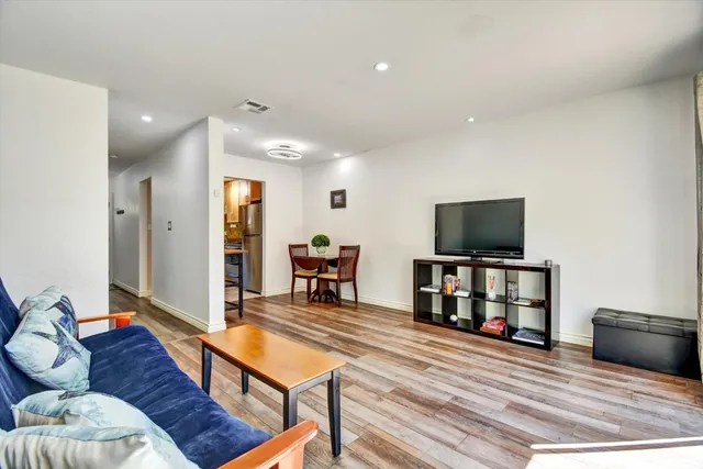 a view of a dining room with furniture and wooden floor
