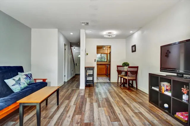 a dining room with furniture and wooden floor