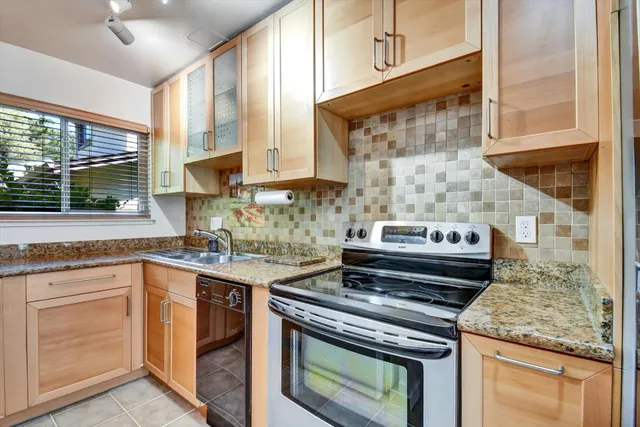 a kitchen that has a sink and a stove
