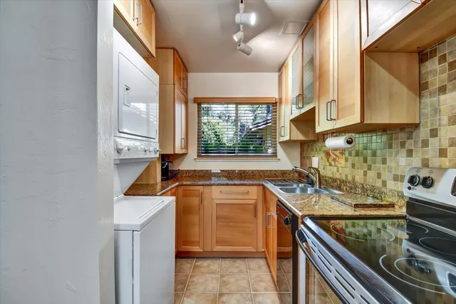 a view of a kitchen with a sink and wooden floor