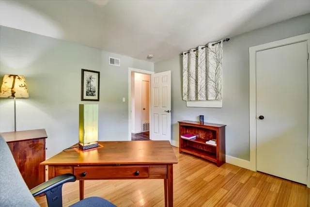 a bedroom with bed and a chandelier