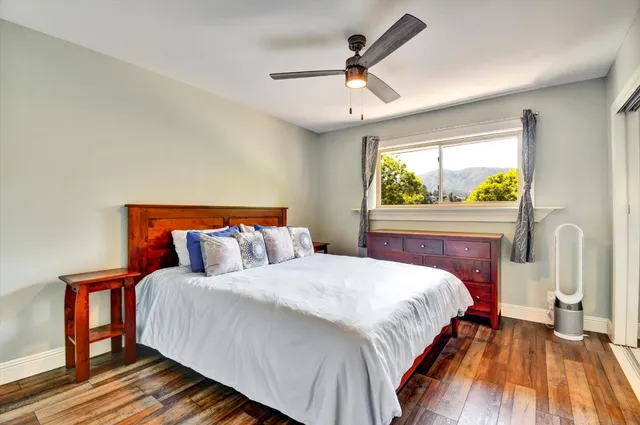 a bedroom with a large bed and a window