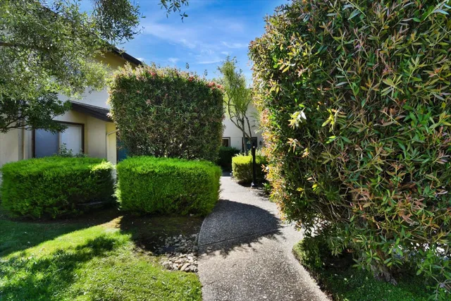 a view of a house with a flower garden
