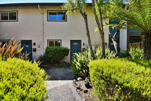 a front view of a house with a garden