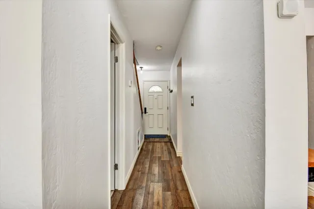 a living room with furniture a flat screen tv and a floor to ceiling window