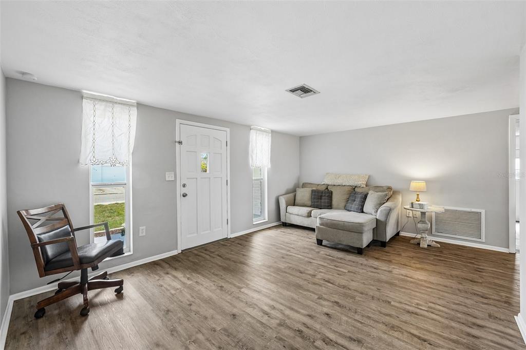 7215 Mayfield Drive Port Richey, FL 34668 - Photo 6 of 52 a living room with furniture and a wooden floor