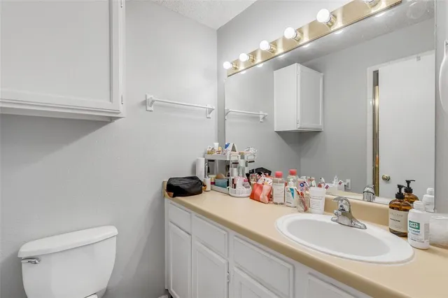 a bathroom with a sink a toilet and a mirror