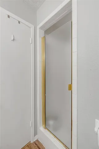 a bathroom with a glass shower door