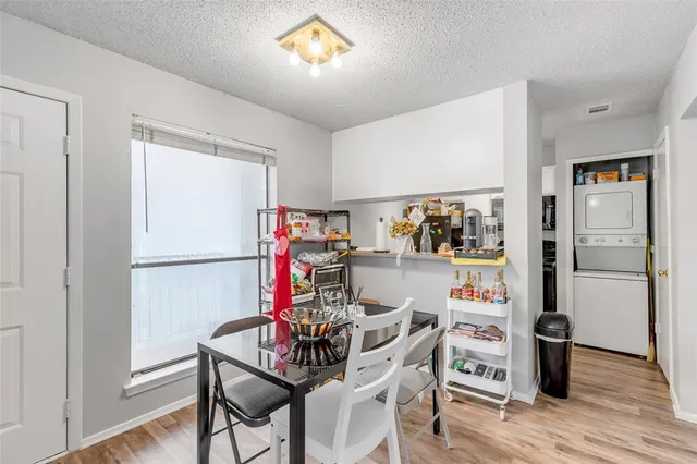 a view of a dining room with furniture wooden floor and kitchen view
