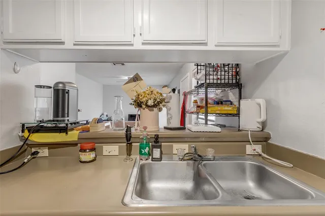 a kitchen with sink refrigerator and window