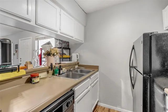 a kitchen with stainless steel appliances granite countertop a sink refrigerator and microwave