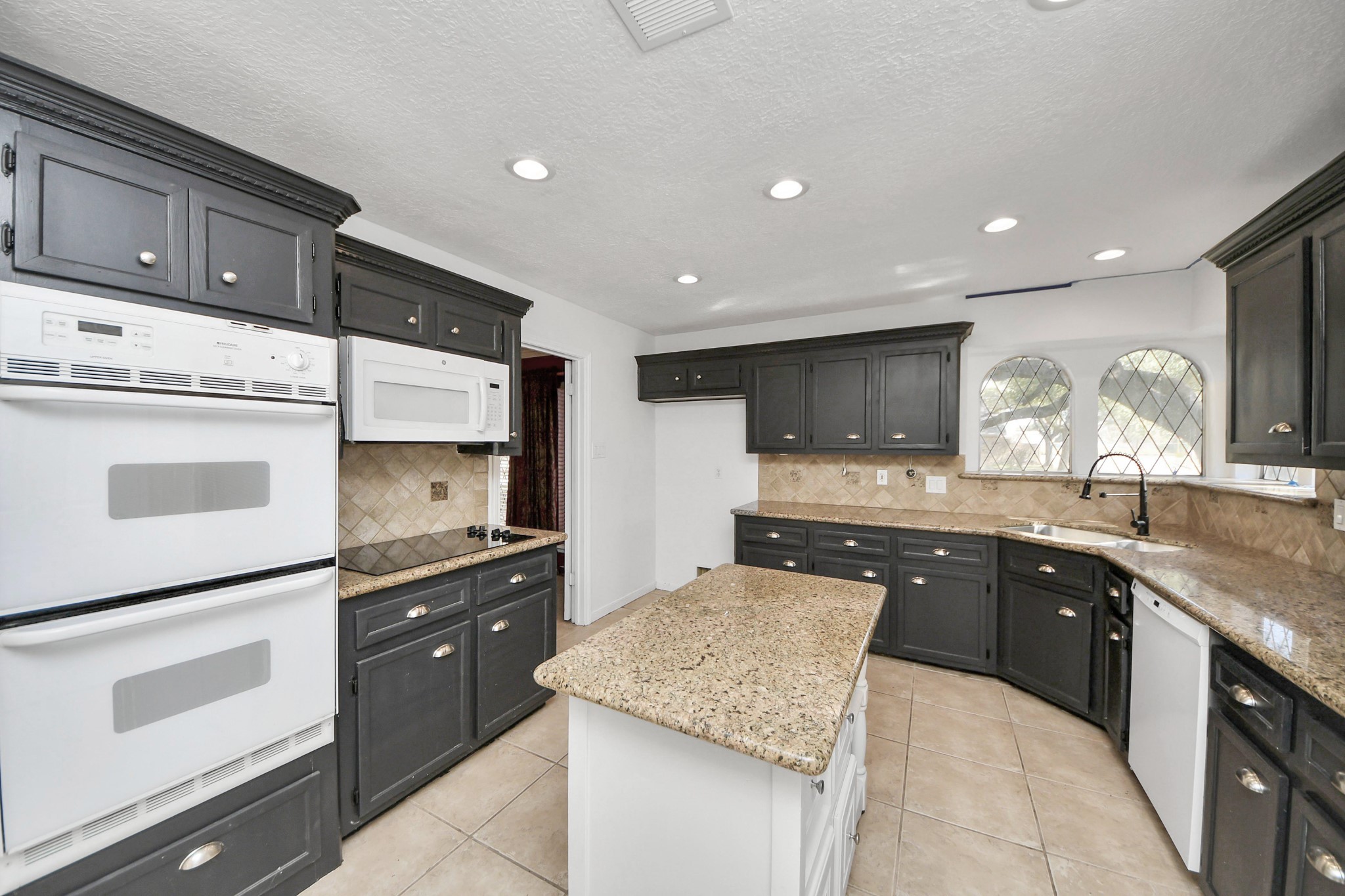 5003 Chantry Drive Houston, TX 77084 - Photo 21 of 49 a kitchen with kitchen island granite countertop appliances cabinets and a counter space