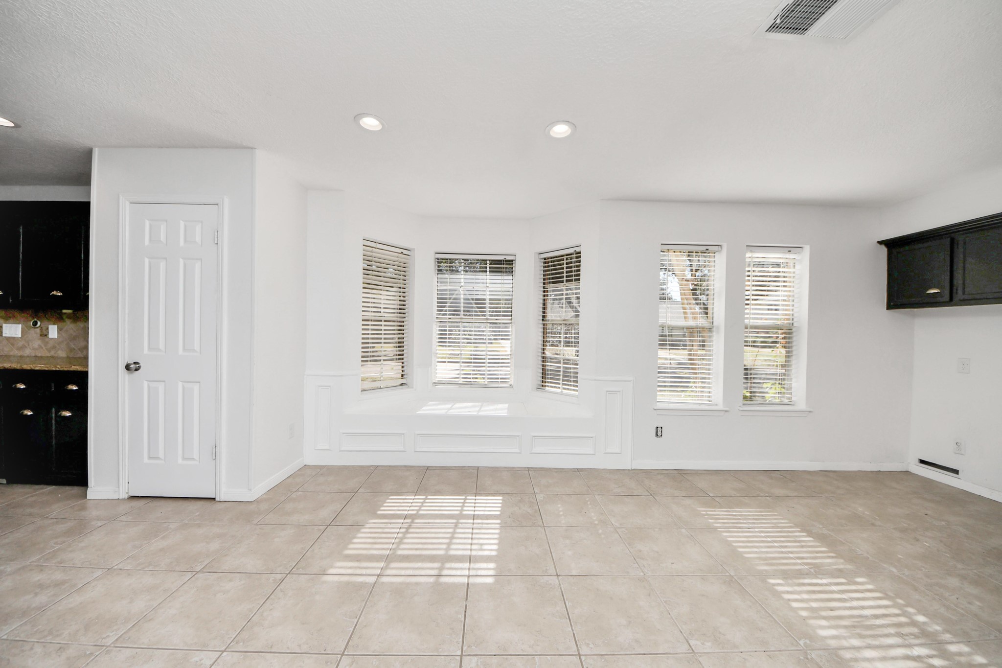5003 Chantry Drive Houston, TX 77084 - Photo 23 of 49 a view of an empty room with a window and a kitchen