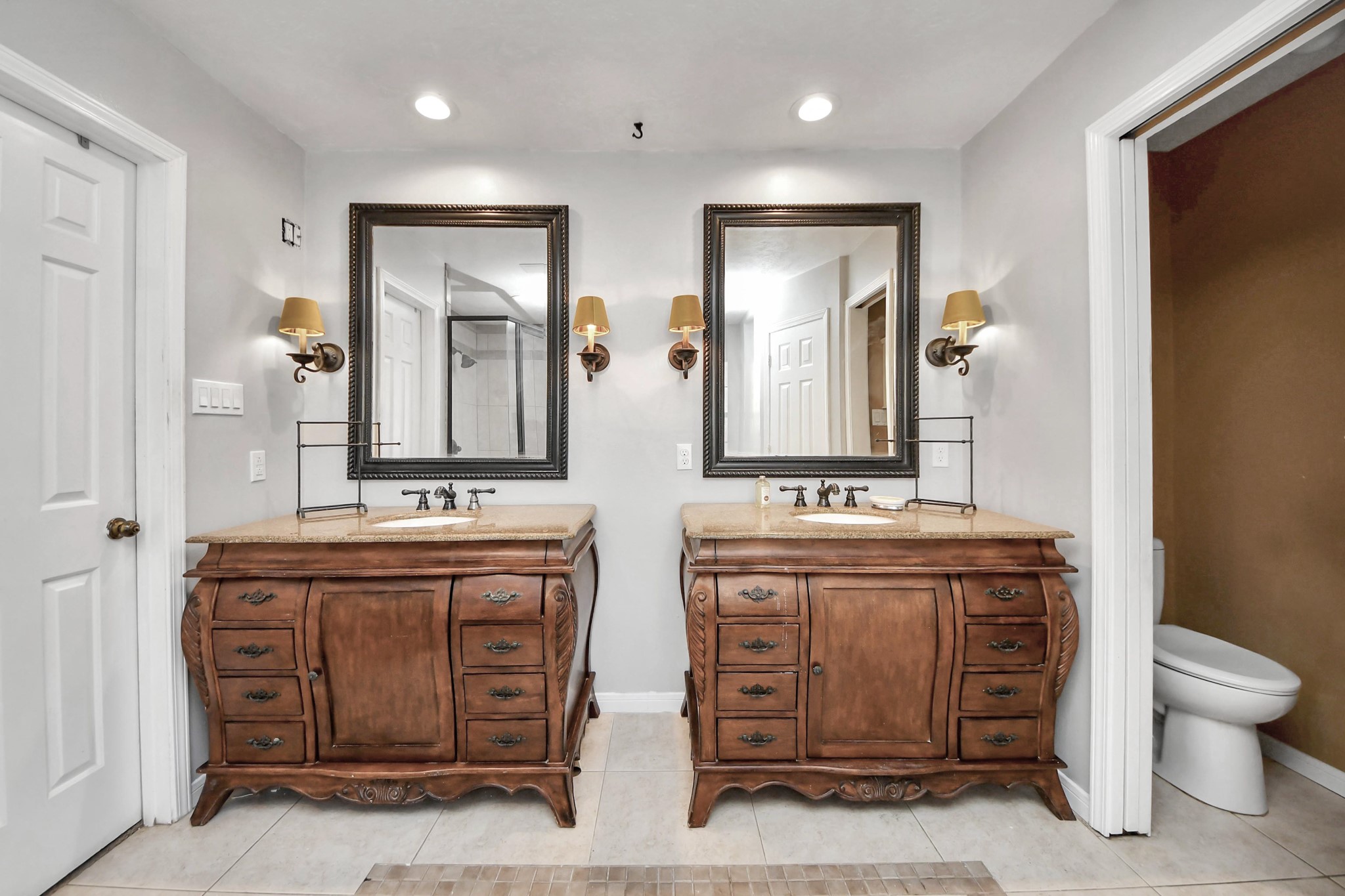 5003 Chantry Drive Houston, TX 77084 - Photo 28 of 49 a spacious bathroom with a granite countertop sink a toilet and a mirror