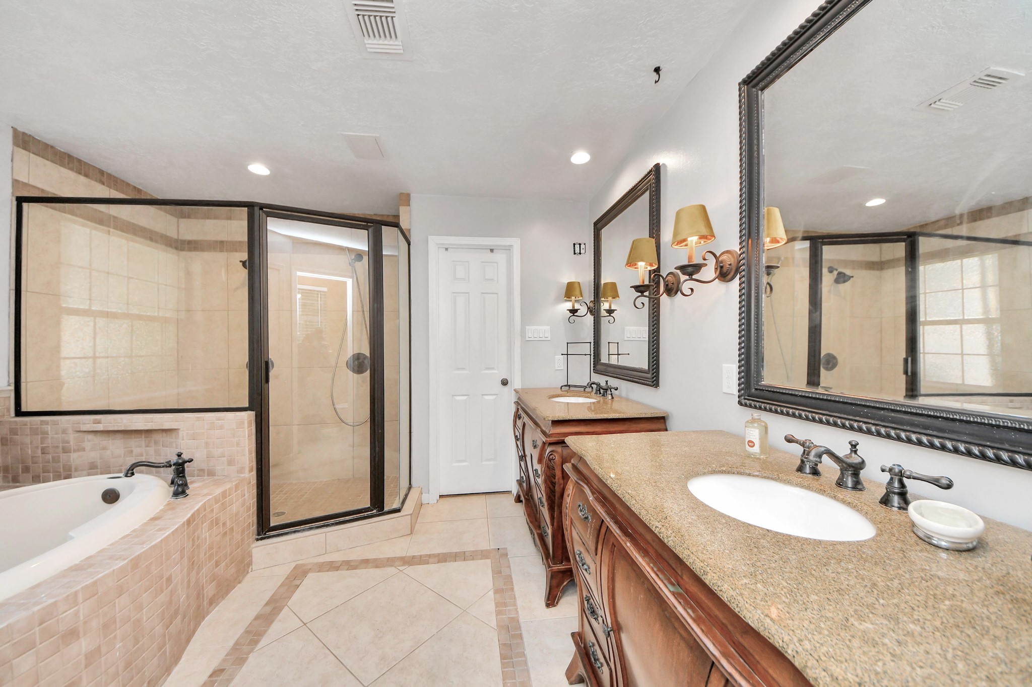 5003 Chantry Drive Houston, TX 77084 - Photo 29 of 49 a bathroom with a granite countertop sink mirror and a bathtub