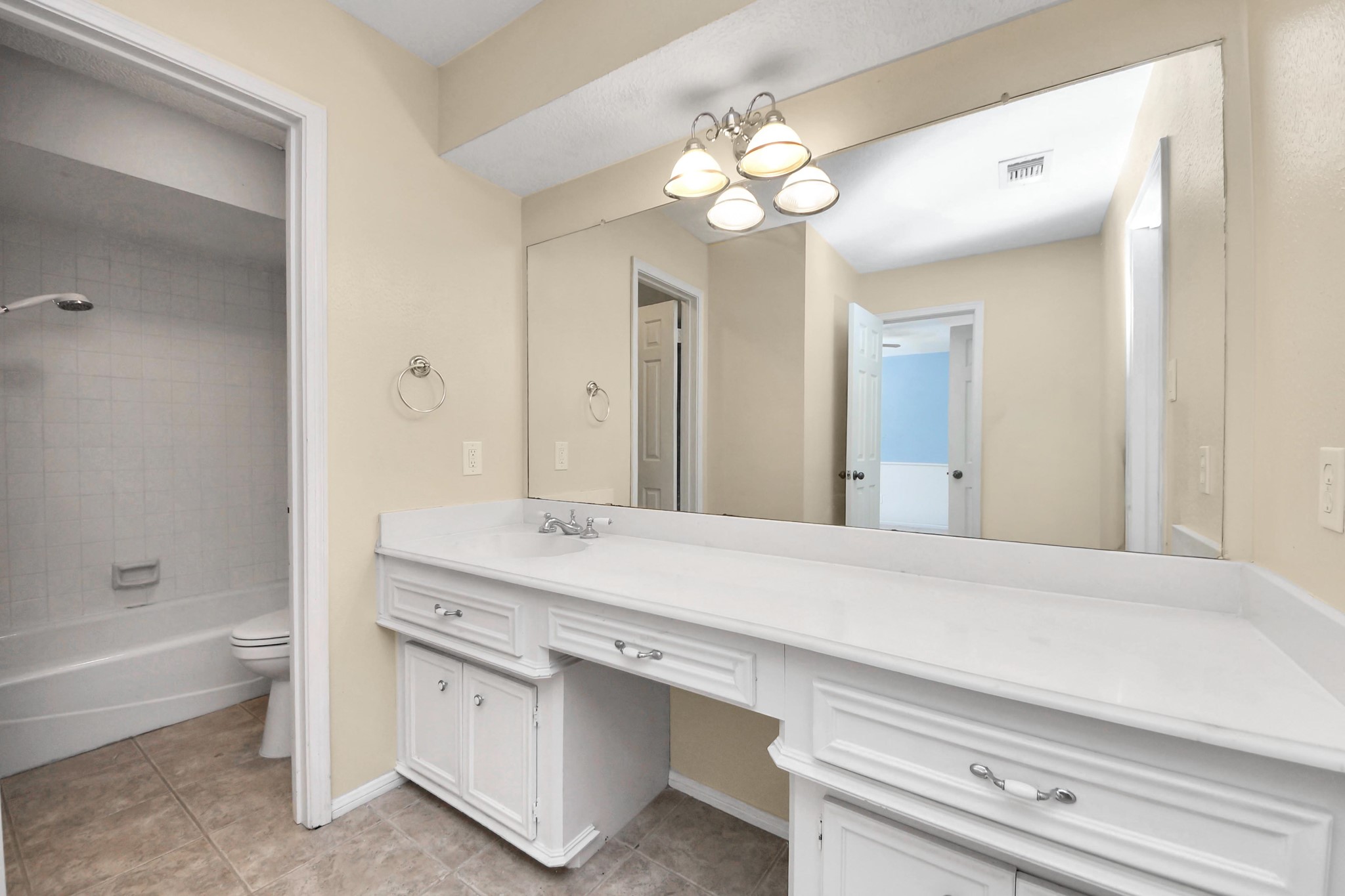 5003 Chantry Drive Houston, TX 77084 - Photo 37 of 49 a bathroom with a sink a large mirror and a bathtub