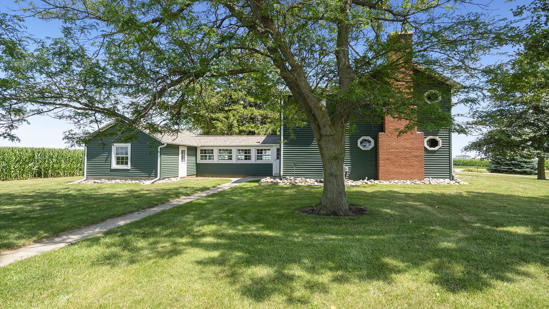 1813 Brooklyn Road Ashton, IL 61006 - Photo 2 of 43 a front view of a house with a garden