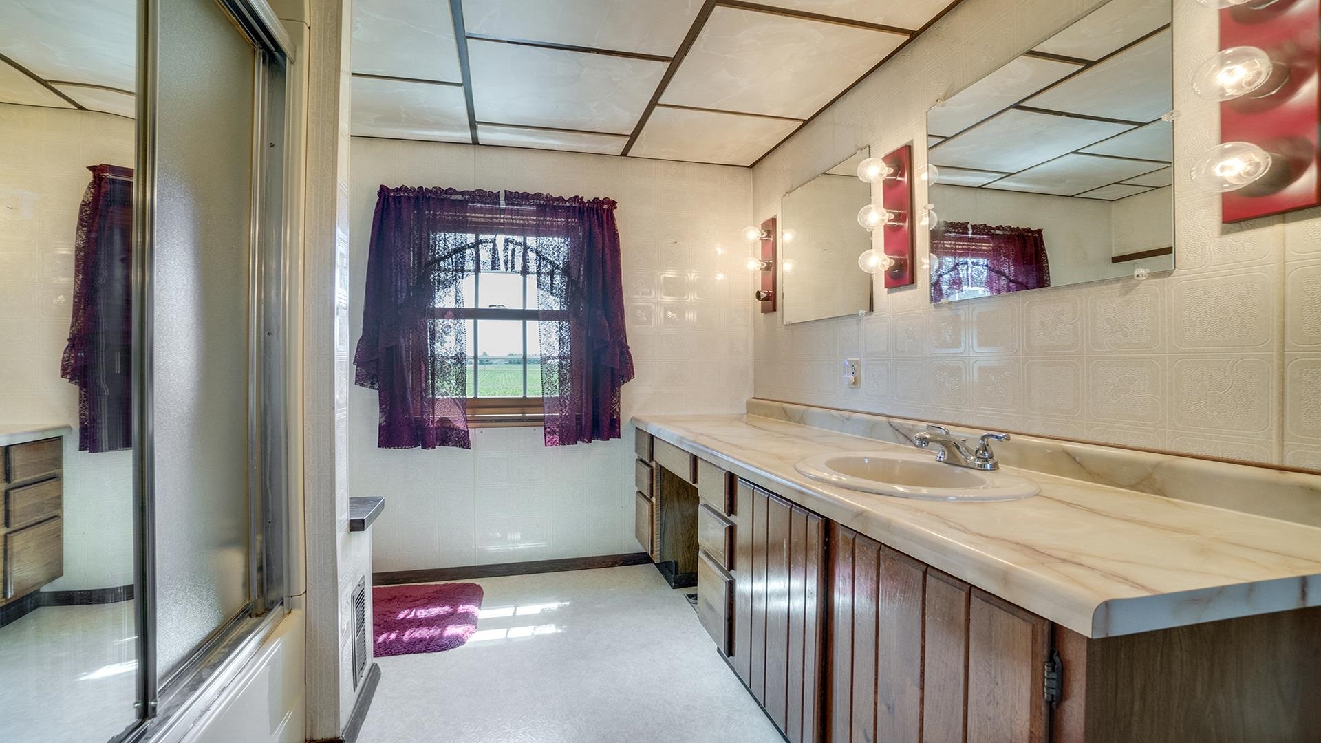 1813 Brooklyn Road Ashton, IL 61006 - Photo 21 of 43 a bathroom with a sink and a mirror
