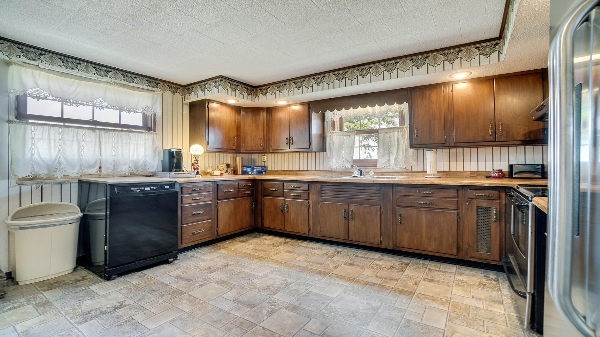 1813 Brooklyn Road Ashton, IL 61006 - Photo 10 of 43 a kitchen with granite countertop a stove a sink dishwasher window and cabinets