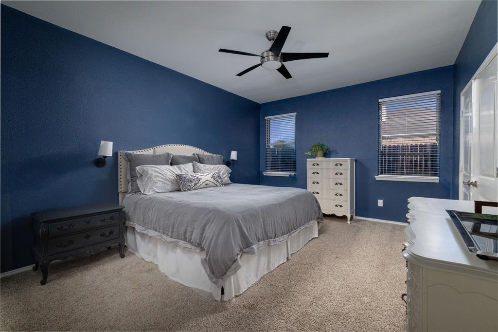 4025 Chisos Rim Trail Fort Worth, TX 76244 - Photo 18 of 40 Carpeted bedroom featuring blue walls and a ceiling fan with integrated lighting