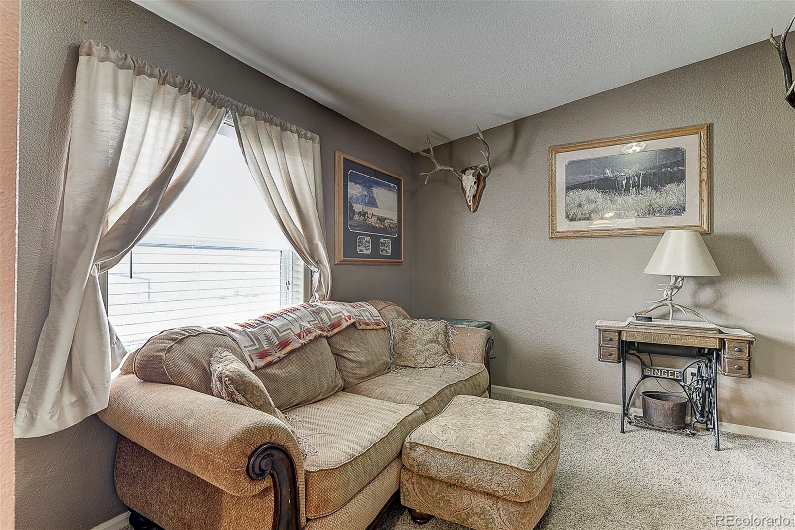 5255 North Yoder Road Yoder, CO 80864 - Photo 11 of 38 a living room with furniture and a window