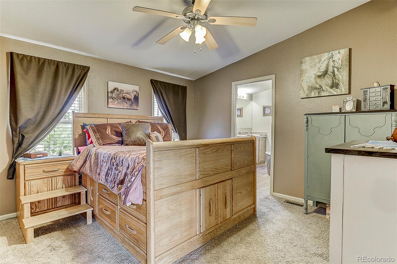 5255 North Yoder Road Yoder, CO 80864 - Photo 17 of 38 a bedroom with a bed and a flat tv screen on the dresser