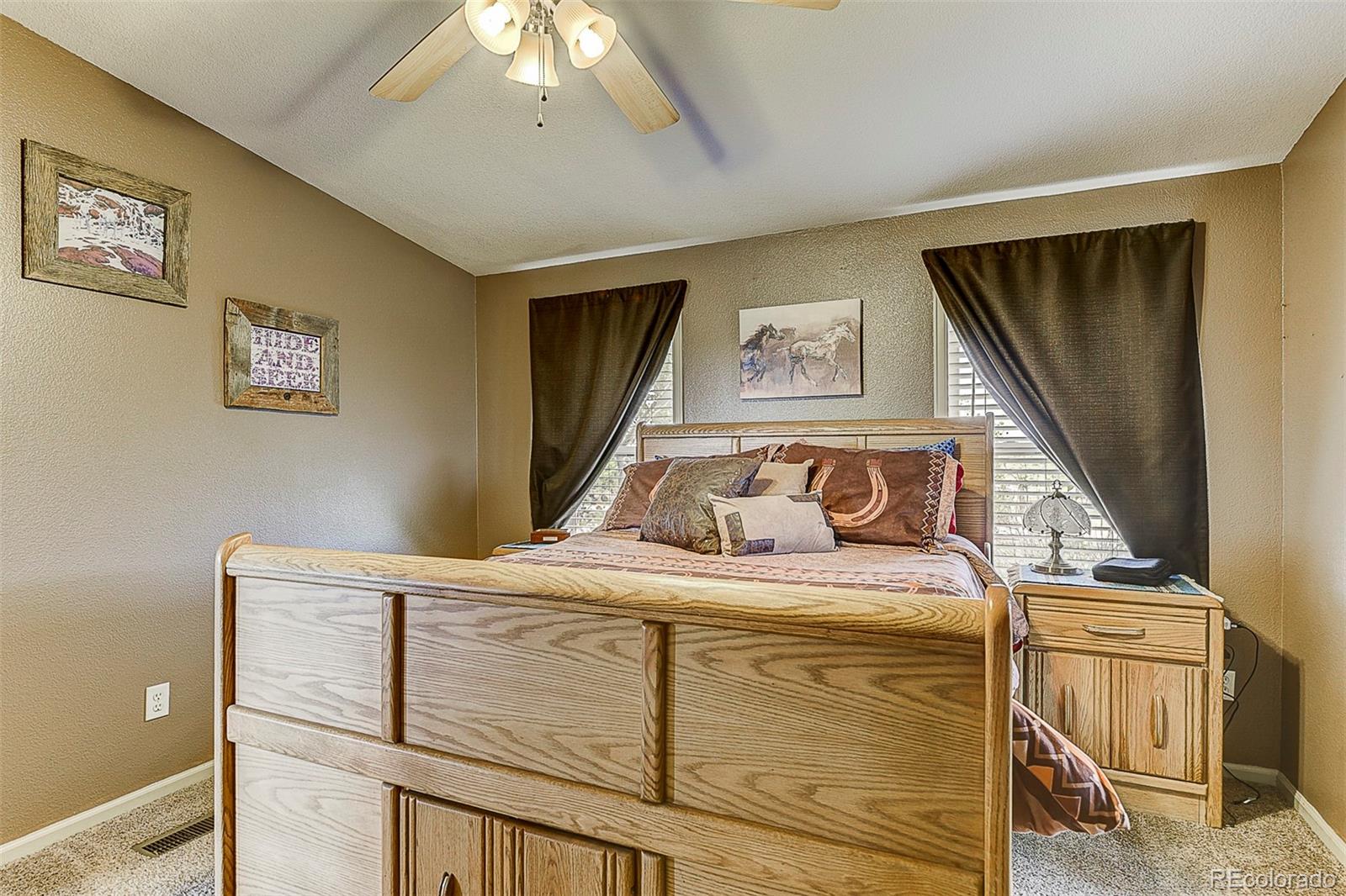 5255 North Yoder Road Yoder, CO 80864 - Photo 19 of 38 a bedroom with bed and paintings on the wall
