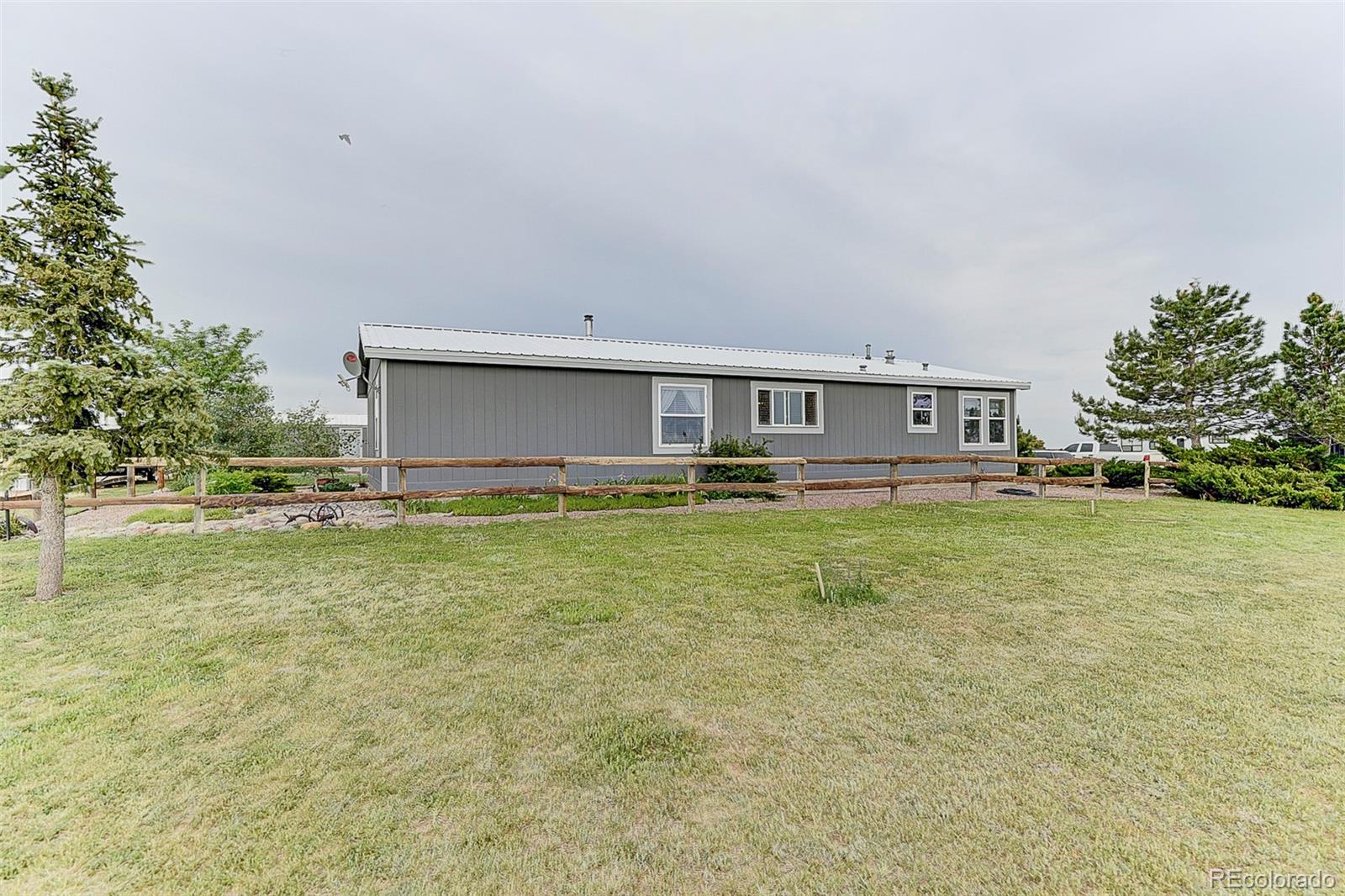 5255 North Yoder Road Yoder, CO 80864 - Photo 28 of 38 a front view of house with yard and trees