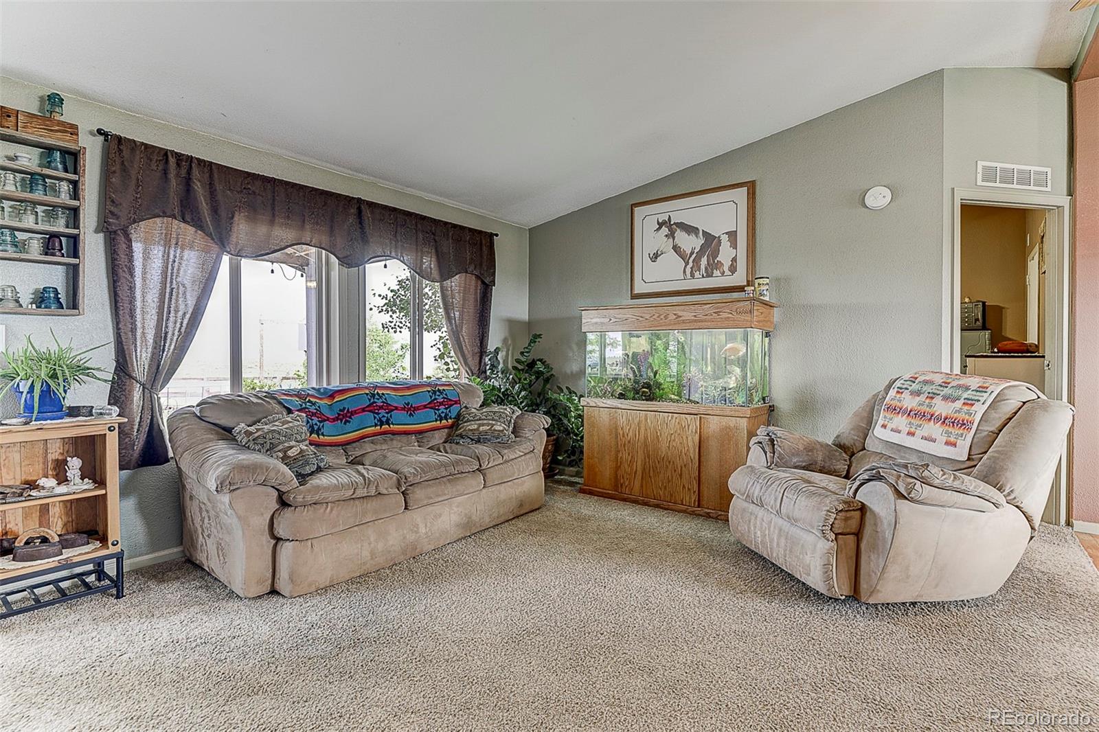 5255 North Yoder Road Yoder, CO 80864 - Photo 4 of 38 a living room with furniture and a large window