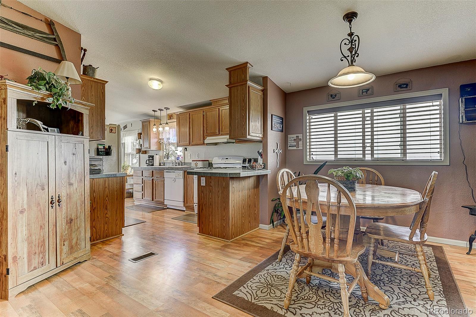 5255 North Yoder Road Yoder, CO 80864 - Photo 6 of 38 a view of a dining room with furniture window and wooden floor