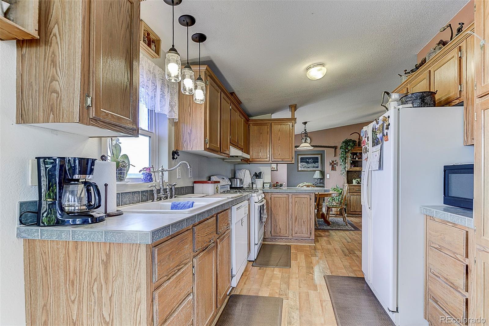 5255 North Yoder Road Yoder, CO 80864 - Photo 10 of 38 a kitchen with refrigerator and cabinets