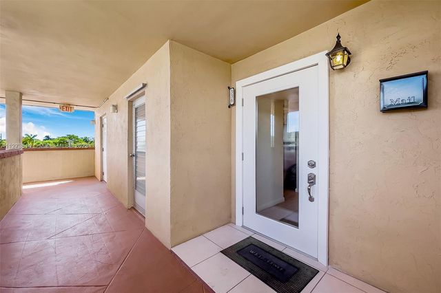 a view of a hallway view with wooden floor and windows