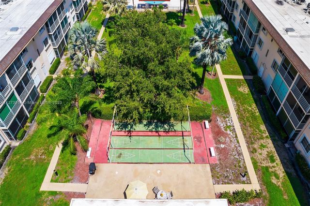 a view of swimming pool with a garden and trees