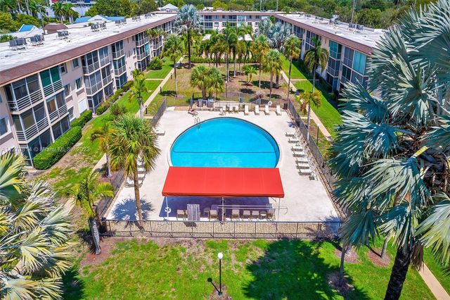 a view of swimming pool with sitting area