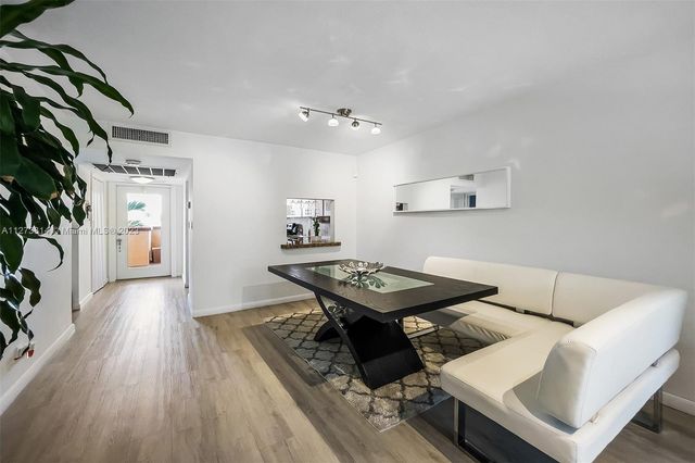 a view of a workspace with furniture and wooden floor