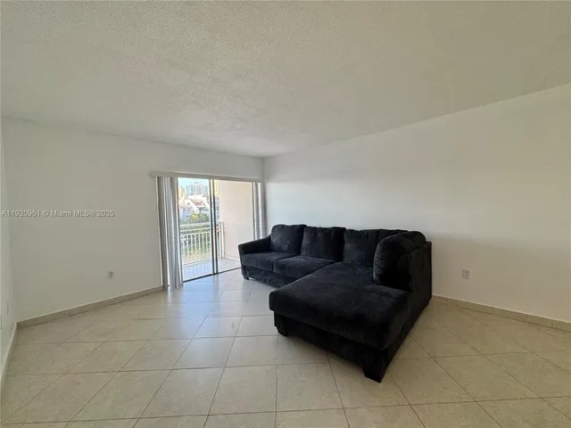 a living room with a couch and a window