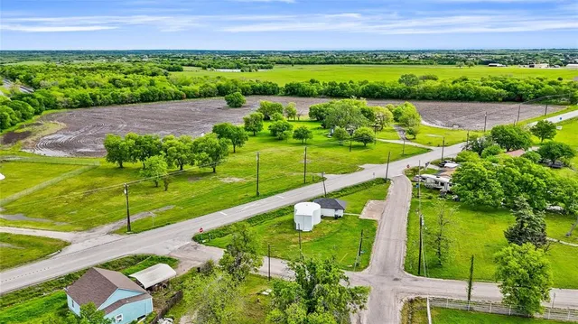a view of kitchen with refrigerator microwave and wooden floor