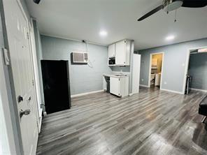 5769 Williams Street Nevada, TX 75173 - Photo 6 of 9 a view of kitchen with refrigerator microwave and wooden floor