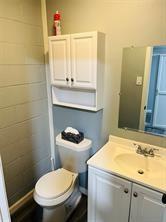 5769 Williams Street Nevada, TX 75173 - Photo 8 of 9 a bathroom with a sink a toilet and a mirror