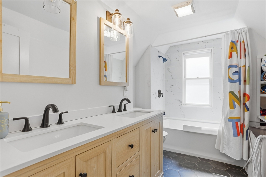 80 Concord Street Maynard, MA 01754 - Photo 19 of 29 a bathroom with a sink a mirror and a window