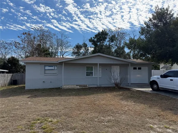 a view of a house with a yard and garage