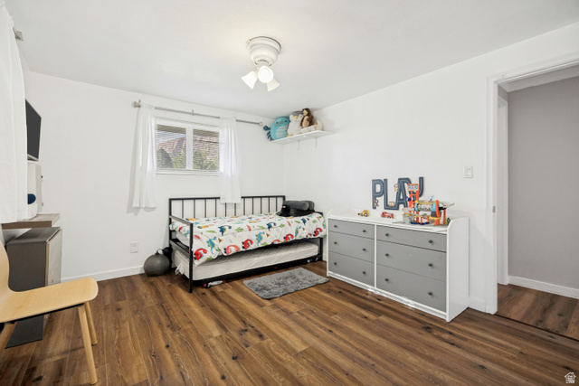 1215 8th Street Ogden, UT 84404 - Photo 17 of 39 Bright room featuring wood-finish flooring, white walls, and a window with white curtains