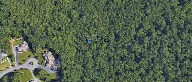 a aerial view of a house with a yard and garden