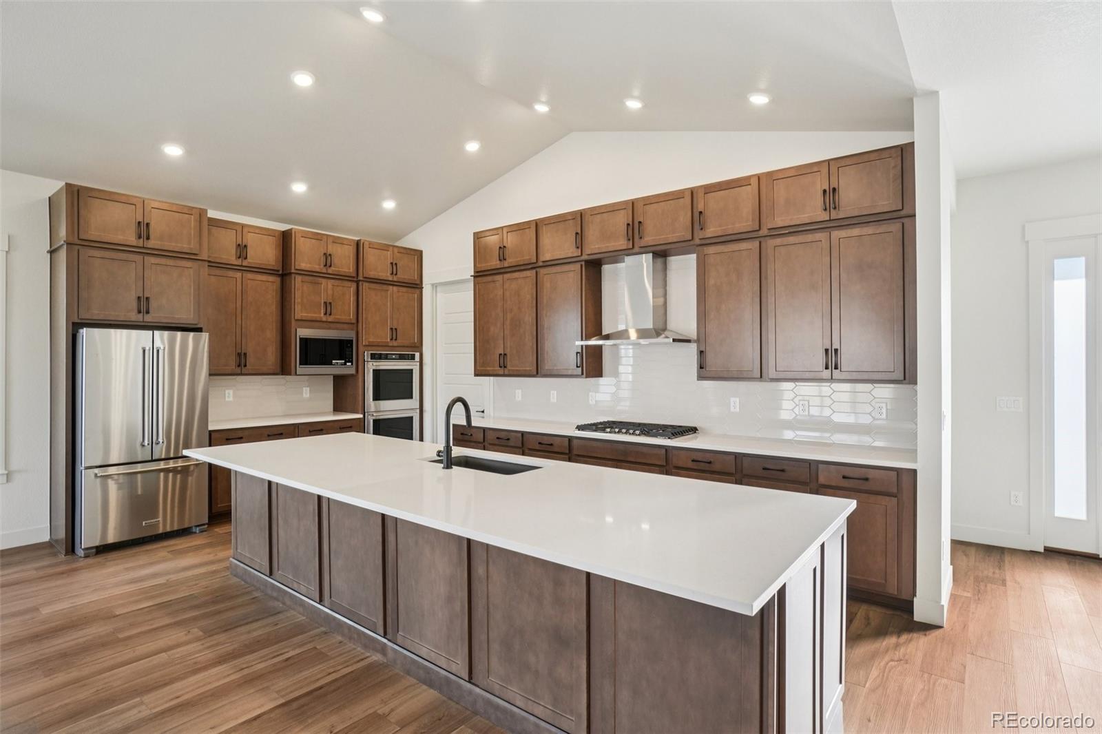 1738 Morningstar Way Fort Collins, CO 80524 - Photo 11 of 47 a kitchen with stainless steel appliances a sink stove and refrigerator